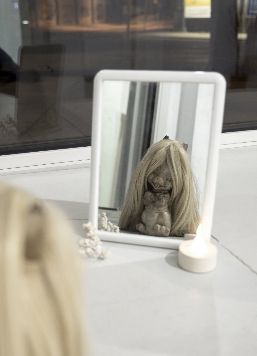 Untitled, 2019, mirror, rubber toy, wig, flower, electric candle